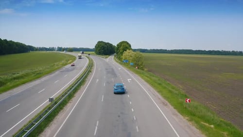 Blue modern car driving throw the road. Flight over the automobile driving.