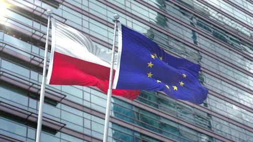 Flags of Poland and European Union Waving Against Modern Office Building