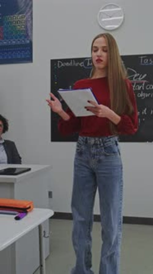 Young Woman Teaching in a Classroom with Students