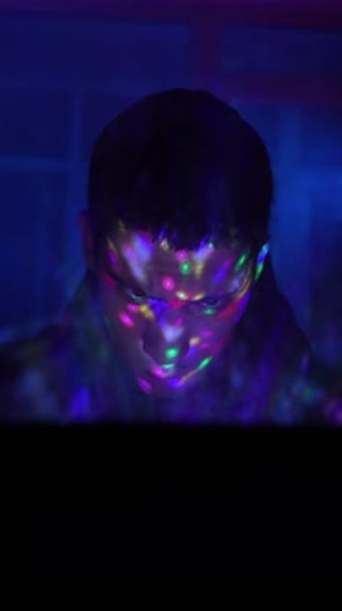Person's Face Lit by Colorful Lights