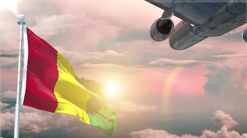 Waving Flag and Airplane Flying Over Sunset Clouds