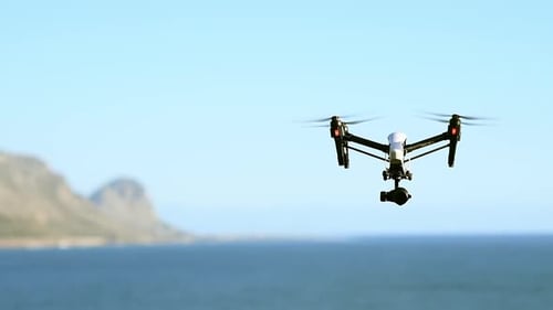 Drone, photography and flight of technology at the beach filming sea landscape with water