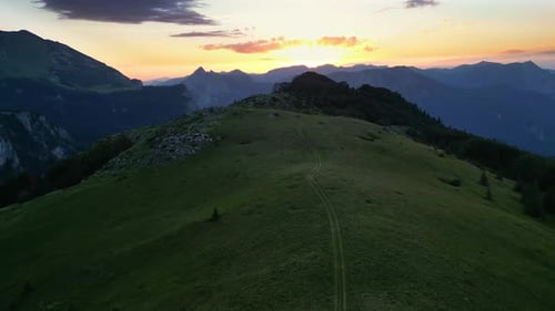 Aerial View of Green Mountain Range During Golden Hour at Sunset Idyllic Mountain Landscape