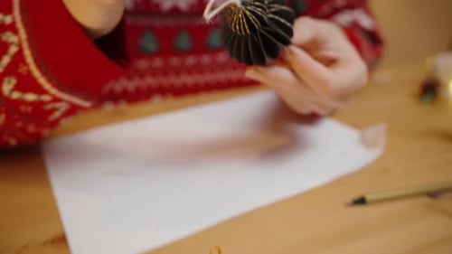 Woman Creates Holiday Ornament at Home