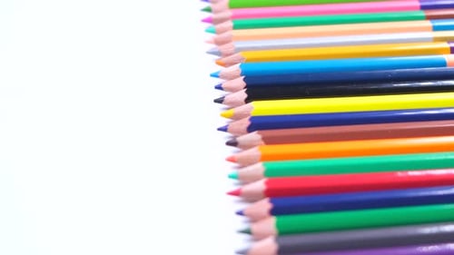 Multicolored Pencils Stacked in a Row Closeup on a White Background the Concept of Creativity