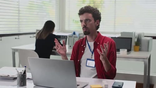 Sales Manager Talking on Video Call with Clients on Laptop in Office