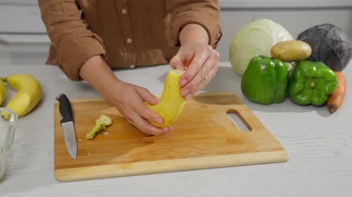 Preparing Fruit: Woman Peels and Slices Bananas