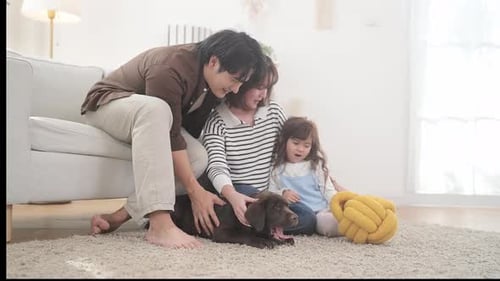 Family Petting Brown Puppy Inside Bright Home
