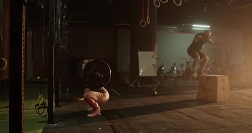 Sportsman and Woman Training Together in Gym