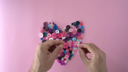 Hands Make Heart Shape with Colorful Buttons