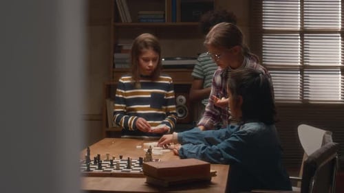 Group of Children Enjoying Game of Dominoes