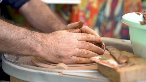 Close view clay on twisted pottery wheel. Ceramist potter.