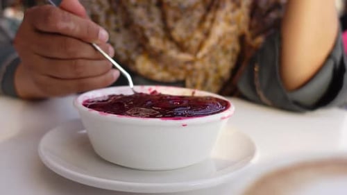 Tasting Delicious Berry Dessert in a Cozy Cafe Setting