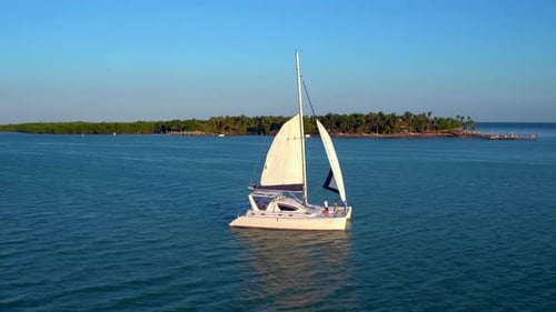 Turquoise ocean waters surround a catamaran near a tropical bahamas island
