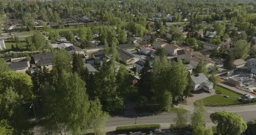 AERIAL: Solar powered homes in a modern neighborhood, sunny, spring day in Finland