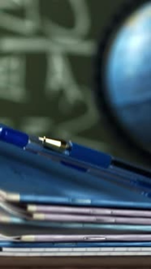 Notebooks and Pens Fall on the School Desk Filmed on a Highspeed Camera at 1000 Fps