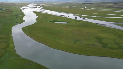 Majestic Aerial Footage of a River Winding Through Iceland Arctic Tundra