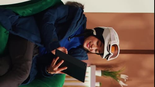 Woman in Ski Helmet Using Tablet Indoors