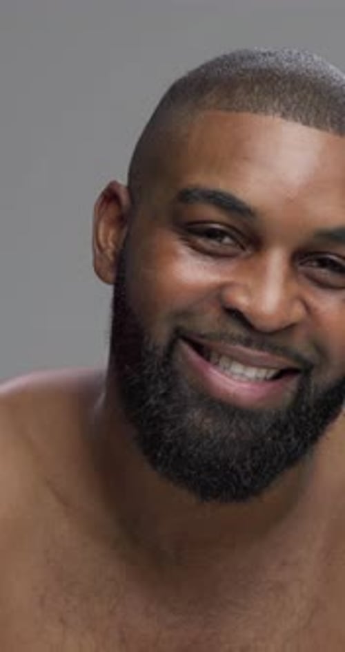 Studio, black man and face with laughing for skincare, grooming and beauty with cosmetics treatment