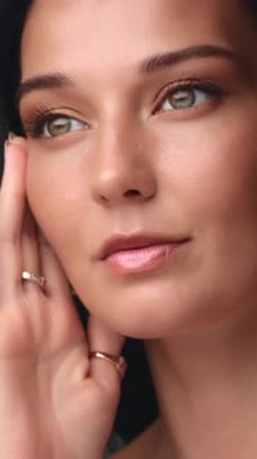Beautiful Woman with Gold Eyeshadow Posing in Studio