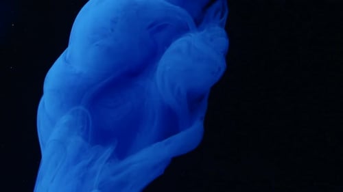 Blue ink in the aquarium on a black background