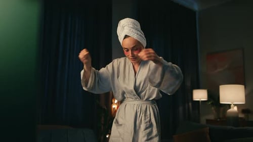 Successful european freelancer in bathrobe explaining online stream on computer at night