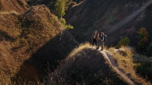Young Mixed Race Couple Observes Landscape From High Hill Top