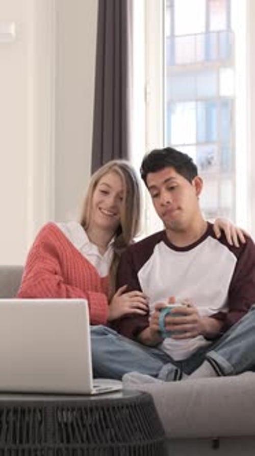 Couple Relaxing at Home with Laptop