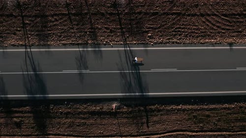 Aerial Drone Shot of Man Ride Longboard on Road