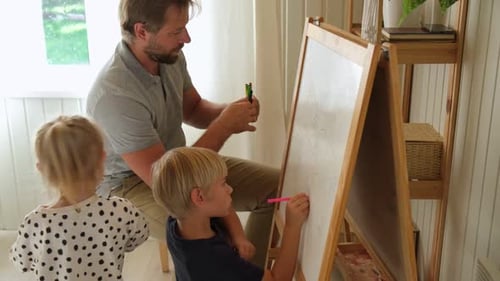 Dad and Kids Drawing Together at Home