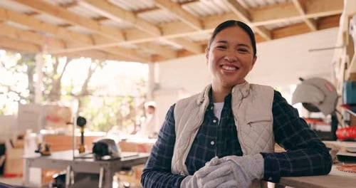 Carpenter woman, face and workshop for construction, wood or smile for pride