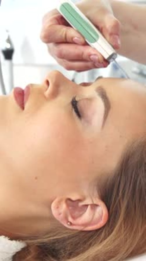 Woman Receiving Professional Facial Beauty Treatment