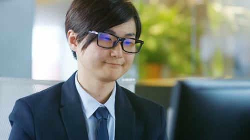 Focused Office Worker at Computer in Modern Workplace