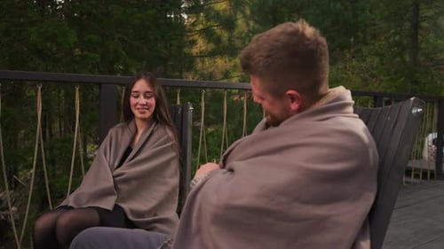 Couple Wraps with Blankets on Glamping Terrace