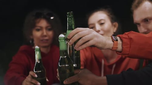 International Group of Friends Close Up Sitting in the Circle at the Cheerful Outdoor Summer Party