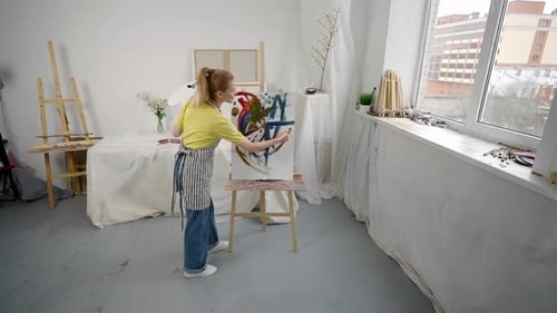 Abstract Style in Fine Art Woman Artist Drawing Picture on Easel in Art Studio Young Adult