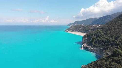 Aerial beautiful beach and water bay in the greek spectacular coast line. Turquoise blue transparent
