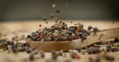 Mixed peppercorns in a super slow motion. Dry mix peppercorns close up.