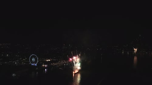 Real fireworks display in black sky with multicolor and different pattern or styles along Thai river
