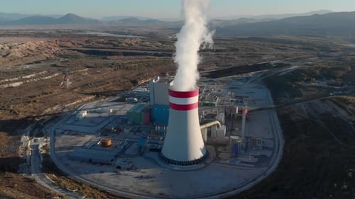 Drone tracking steam from a coal fired power station plant Sunset blue clear sky