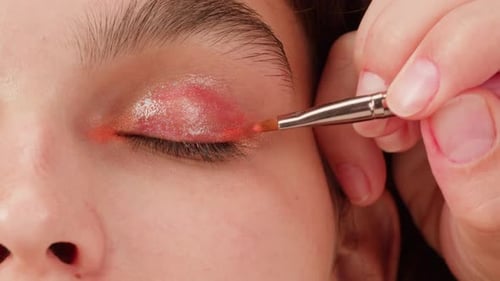 Applying Shimmering Eyeshadow with a Brush Close Up