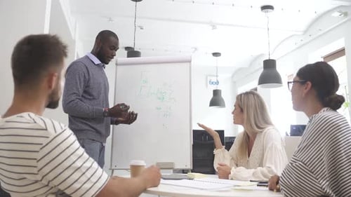 Multicultural Young People Collaborating on Working Strategy in Office