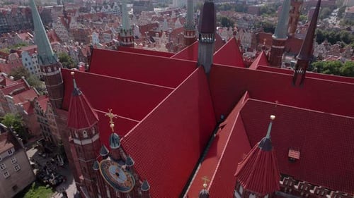 Drone Flight Around the Ancient Cathedral in the Center of the Old European Town with Tile Roofs