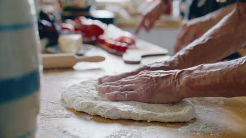 Woman Teaching Young Adult How to Make Pizza