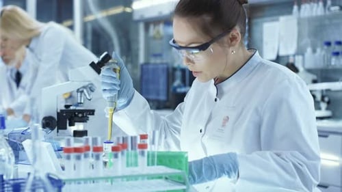 Scientist Working with Test Tubes in a Bright Lab