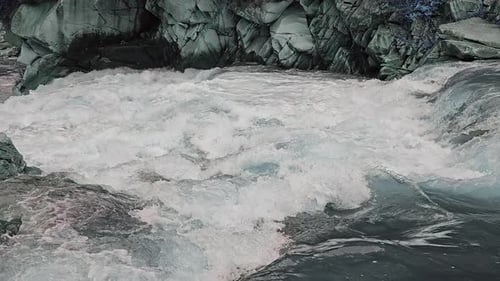 Rushing Riwer Through Rocky Rapids A Powerful Stream of Water Rushes Through Rocky Rapids Creating a