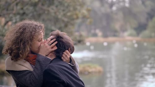 romantic young couple at the park kissing passionalety. They talking and joking