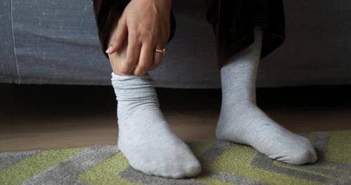 Women Scratches Legs and Feet with Itchy Skin