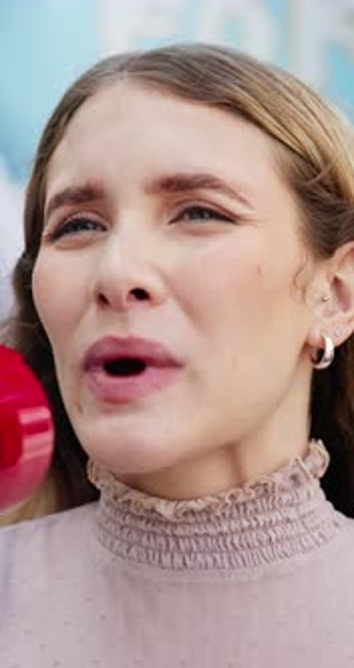 Young Woman Speaking Into a Megaphone Close Up