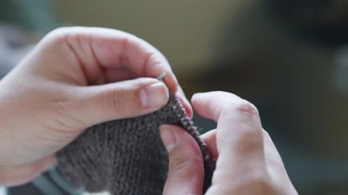 Close Up of Hands Knitting with Knitting Needles